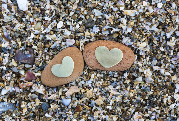 Two Hearts on Red Rocks on Sand