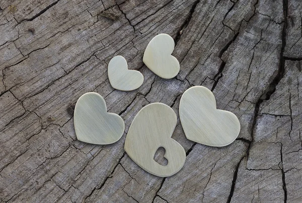 Cinco corazones de metal en madera — Foto de Stock