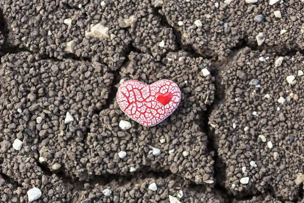 Red Speckled Heart on Dry Soil — Stock Photo, Image