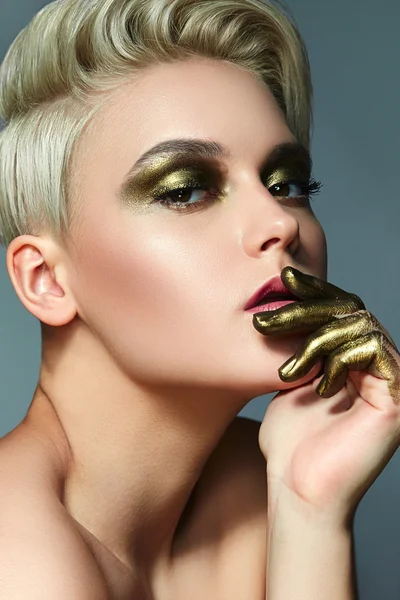 Girl with short white hair and makeup antique gold. — Stock Photo, Image