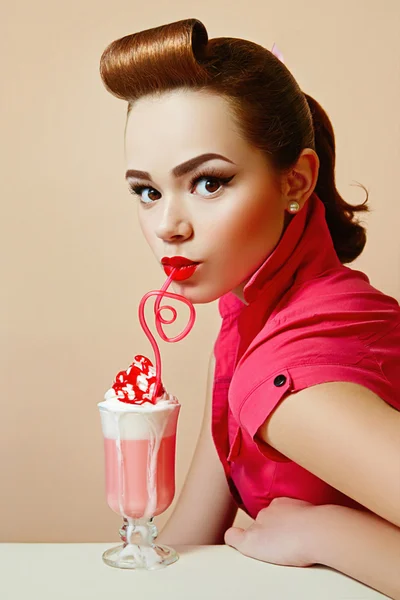 Girl in retro style pin-up style  with a milkshake and a pink straw. — Stock Photo, Image