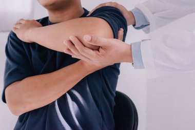 Professional therapists are stretching muscles, Physiotherapy, sport injury rehabilitation. Senior man exercises in center for chiropractic.