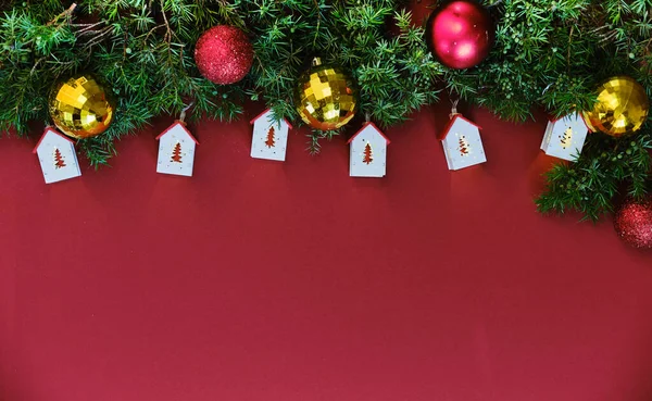 Toy house and pine branches with gift on redbackground. — Stock Photo, Image