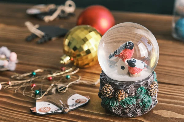Closeup of a christmas toys and snow globe — Stock Photo, Image