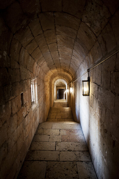 Old vaulted passage with faint illumination