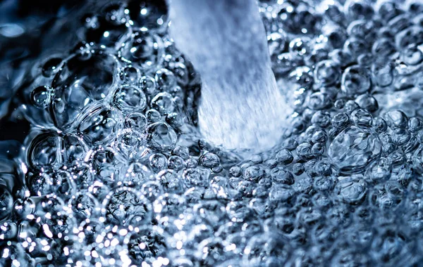 Water bubbles close-up. Tap water from a faucet. Extreme macro close-up. Tap water. High quality foto.