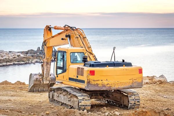 Graafmachine loader machine met zonsondergang achtergrond. — Stockfoto