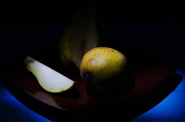 Sonbahar armudu sade bir hayat. Kusursuz armut silueti, düşük ışık ve derin gölge..