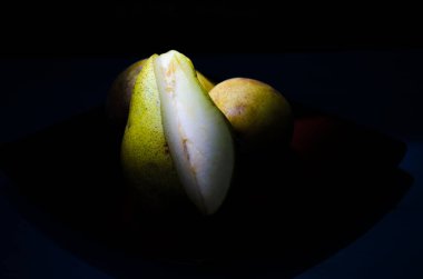 Sonbahar armudu sade bir hayat. Kusursuz armut silueti, düşük ışık ve derin gölge..