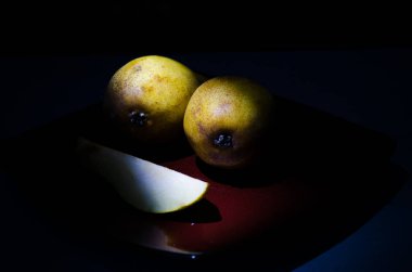 Sonbahar armudu sade bir hayat. Kusursuz armut silueti, düşük ışık ve derin gölge..