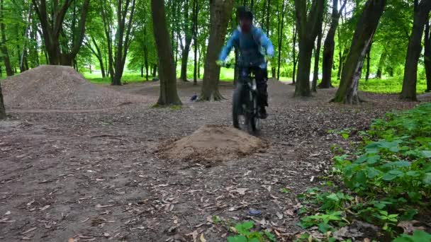 Amateur rider on the bicycle in the spring park — Stock Video