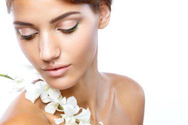 Açık yüz doğal olan kadın makyaj onun saçları hafif bir arka plan üzerinde beyaz çiçekli