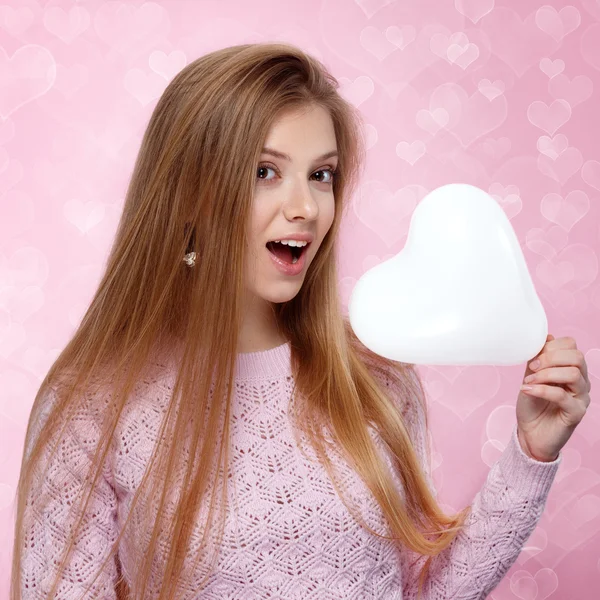 Valentines Day. Sweet blonde woman holding a balloon. heartshaped bokeh background Joyful — Stock Photo, Image
