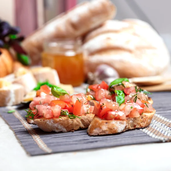 Italian tomato bruschetta with basil — Stock Photo, Image