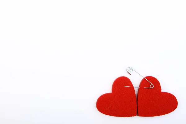 Red hearts pinned with a safety pin — Stock Photo, Image