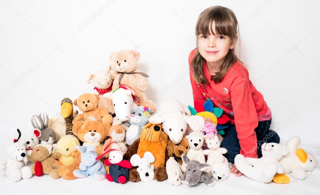 Child with stuffed animals