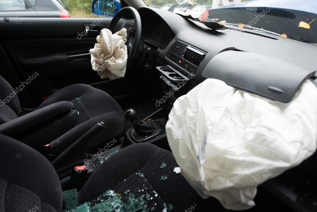 Damaged car with deployed airbags