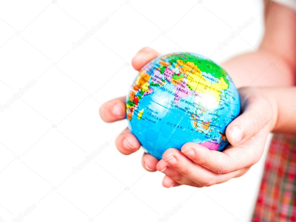 Hands of a child holding a globe