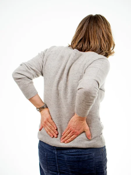 Mulher segura as costas — Fotografia de Stock