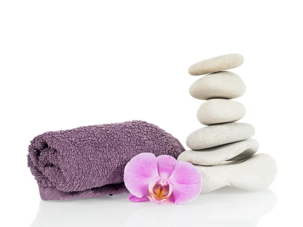 Stone tower with towel and orchid flower Stock Photo