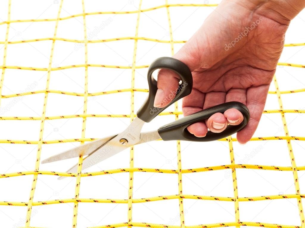 Hand with scissors and yellow network