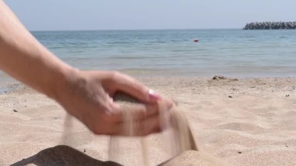 Woman Pouring Fine Sand Through Fingers — Stock Video