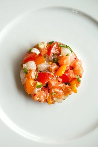 Salmon tartar with peppers and tomatoes — Stock Photo, Image