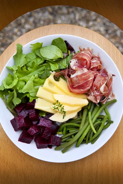 Salad, ham and cheese on a plate — Stok fotoğraf