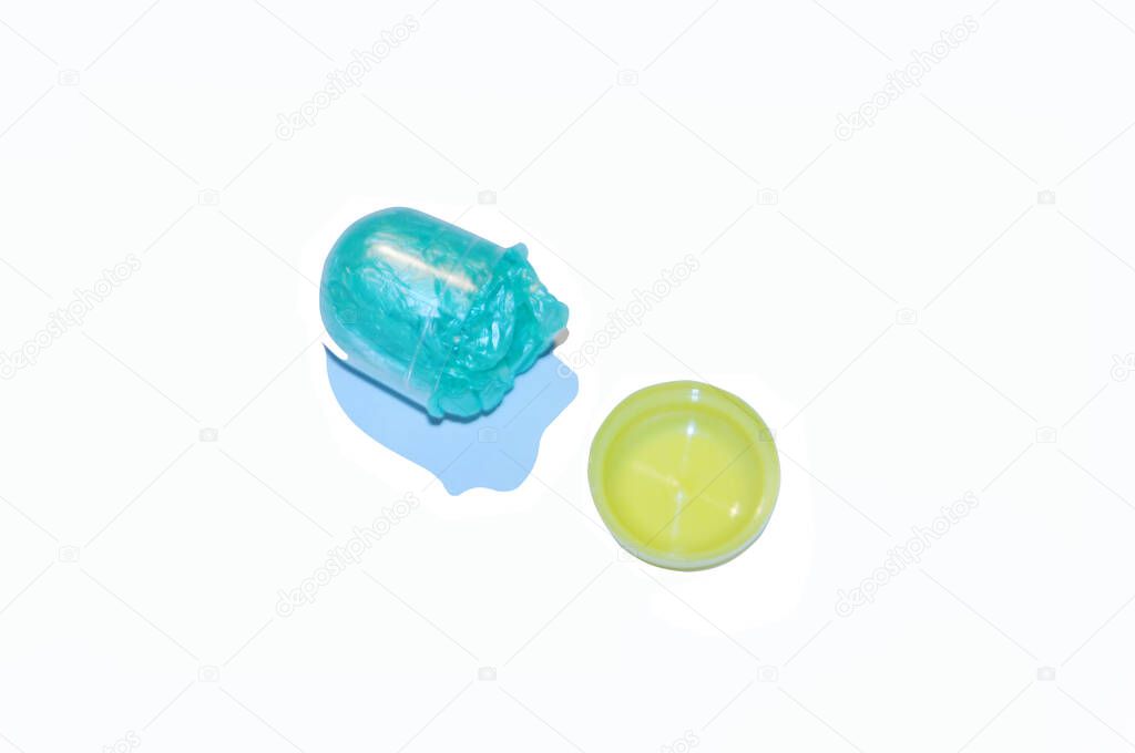 Isolated blue shoe covers in individual capsules with yellow caps. Disposable shoe covers. Protection concept. 