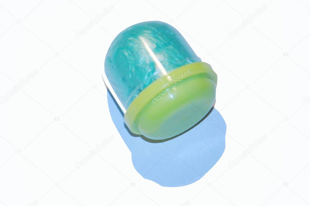 Isolated blue shoe covers in individual capsules with yellow caps. Disposable shoe covers. Protection concept.