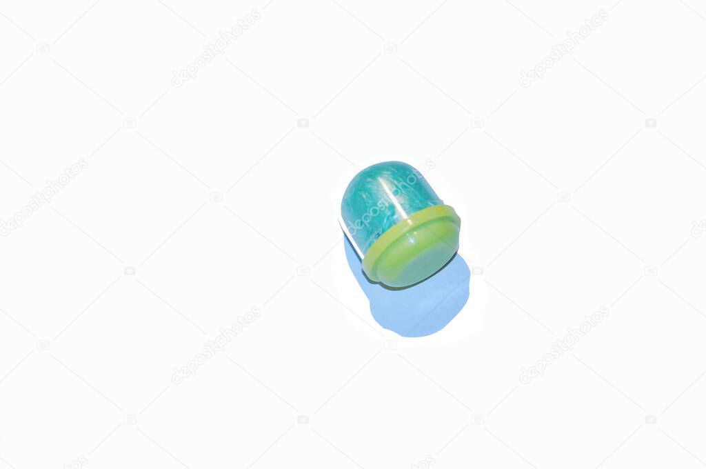 Isolated blue shoe covers in individual capsules with yellow caps. Disposable shoe covers. Protection concept.