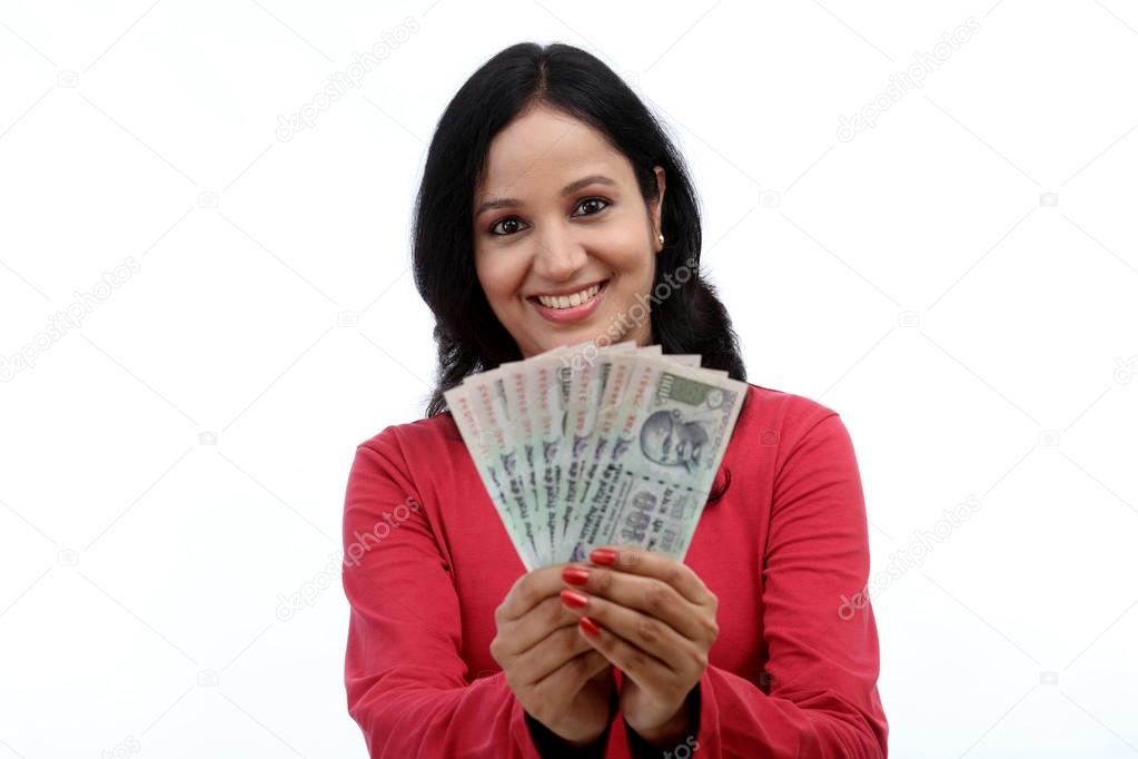 Young woman holding Indian currency