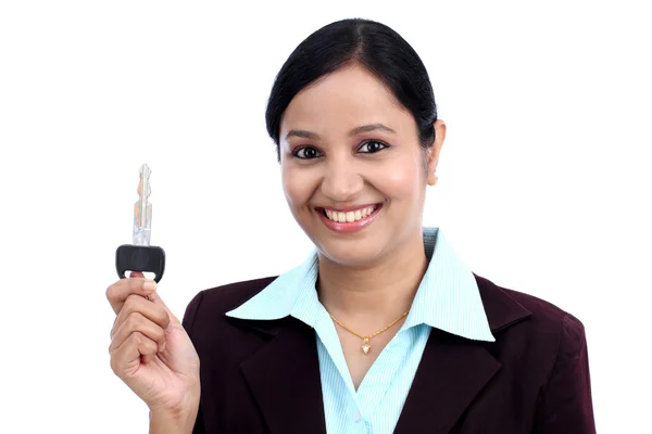 Happy young business woman holding key — Stock Photo, Image