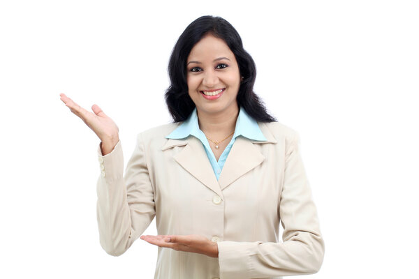 Happy young business woman presenting a copy space against white