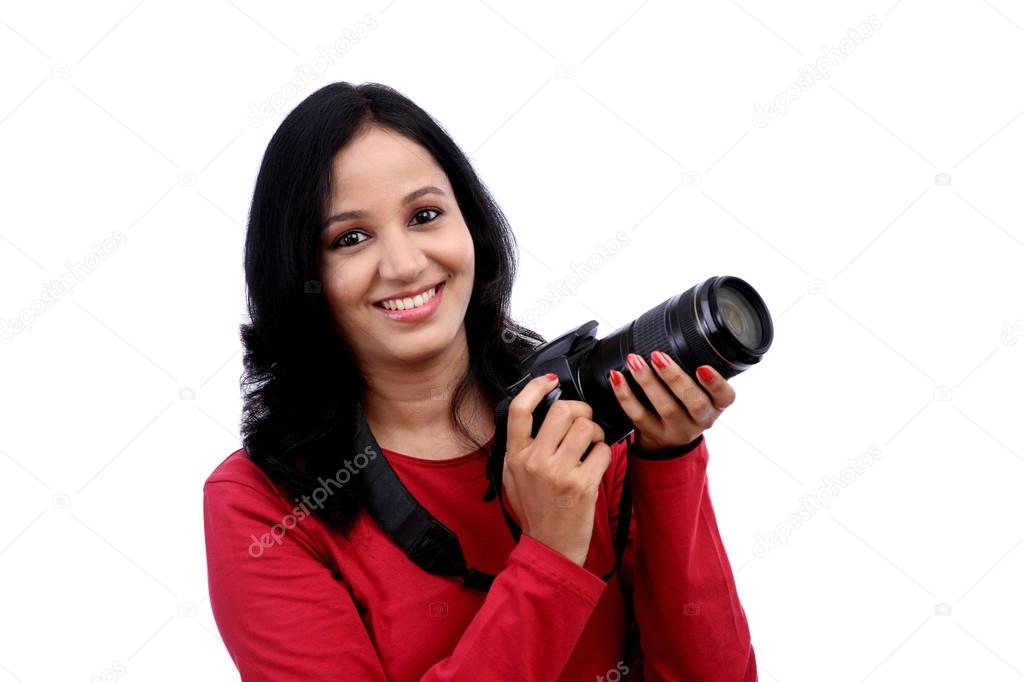 Young woman photographer with camera 