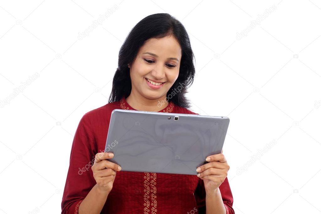 Smiling beautiful young woman with tablet computer