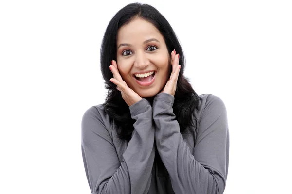 Surprised young woman against white background — Stock Photo, Image