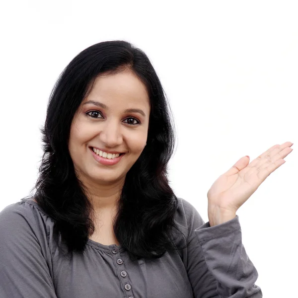 Smiling young woman showing isolated presentation — Stock Photo, Image