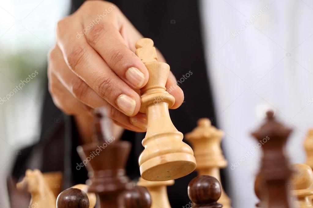 Business woman playing chess