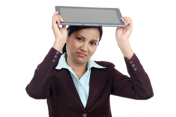 Angry businesswoman throwing her tablet computer — Stock Photo, Image