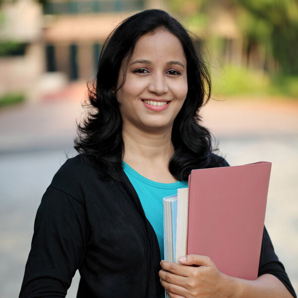 Happy young female student at college campus