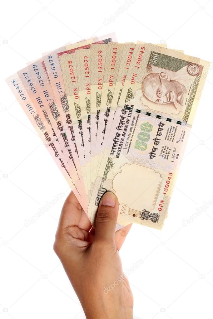 Hand with Indian rupee notes 