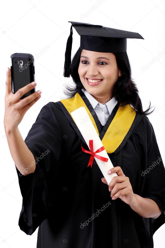 Young female graduated student taking selfie