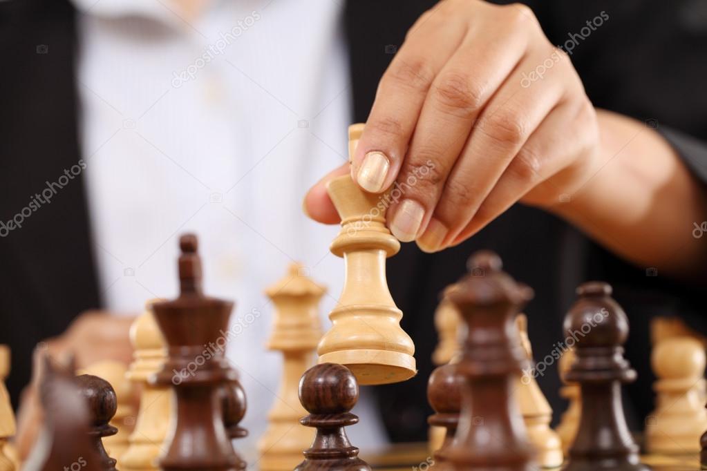 Business woman playing chess