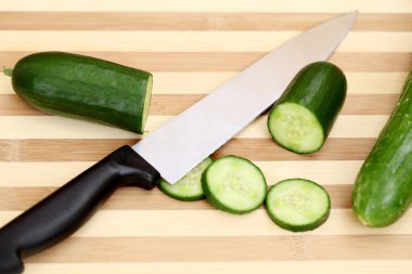 Salatalık dilimleri ve doğrama kurulu üzerinde bıçak