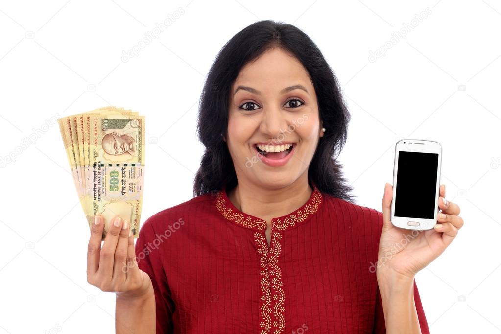 Excited woman holding Indian currency and mobile phone