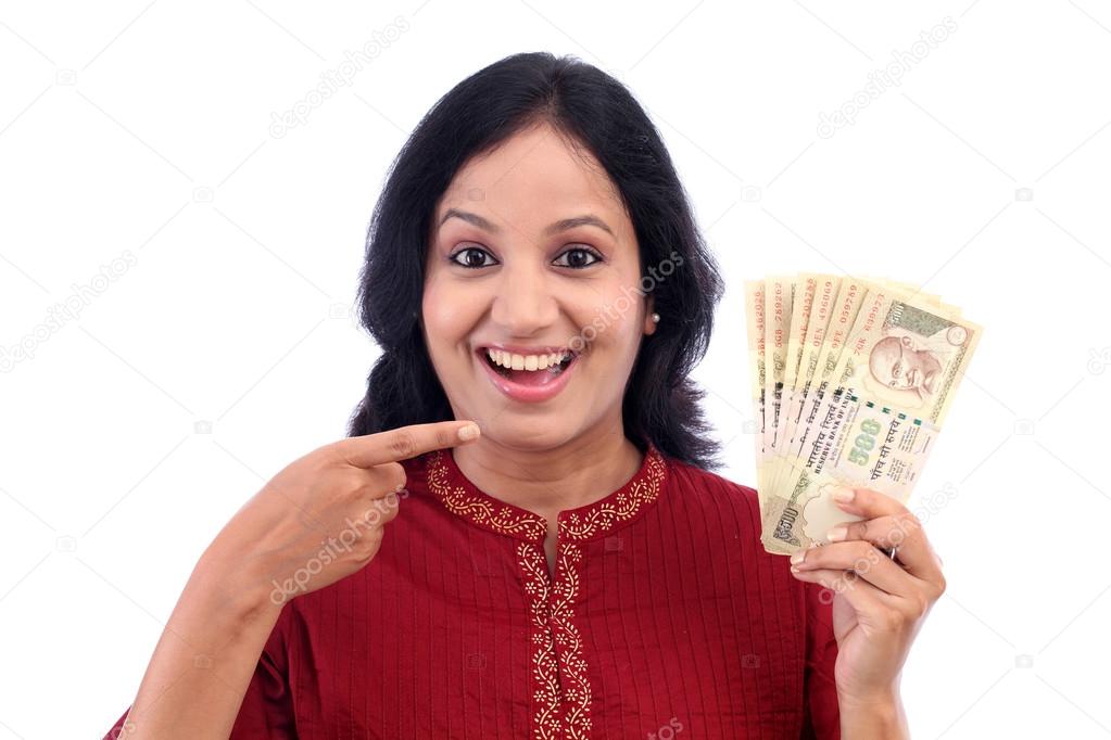 Excited woman holding five hundred rupee notes