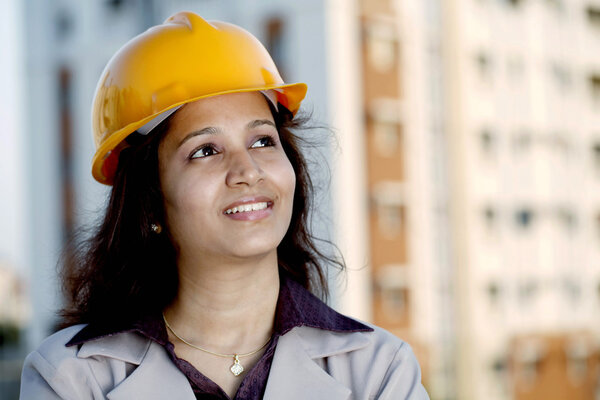Female construction engineer looking up