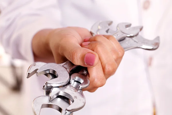 Hand holding spanners — Stock Photo, Image