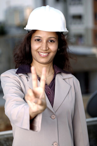 Female architect showing victory sign